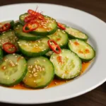 Beautifully plated Din Tai Fung cucumber salad in white bowl