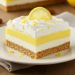 Slice of Lemon Lush Dessert with Whipped Topping and Zest