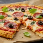 Baked chicken crust pizza topped with melted mozzarella and pepperoni