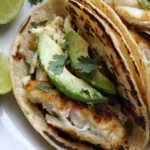 Crispy air fryer fish tacos with lime, slaw, and avocado