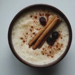 Bowl of creamy rice pudding with raisins and cinnamon