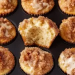 Five golden-brown coffee cake muffins with streusel topping