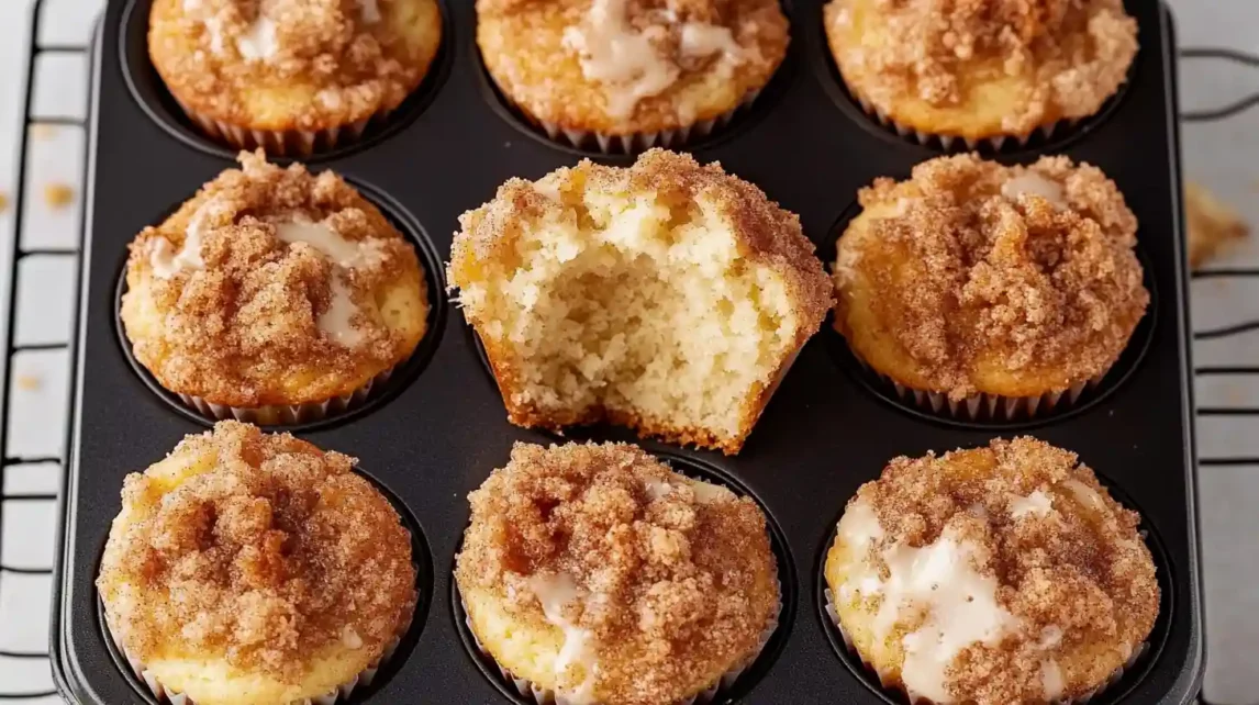 Five golden-brown coffee cake muffins with streusel topping