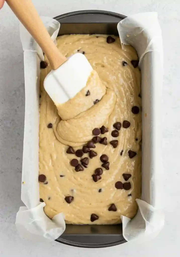 Banana bread batter spread evenly in a loaf pan before baking