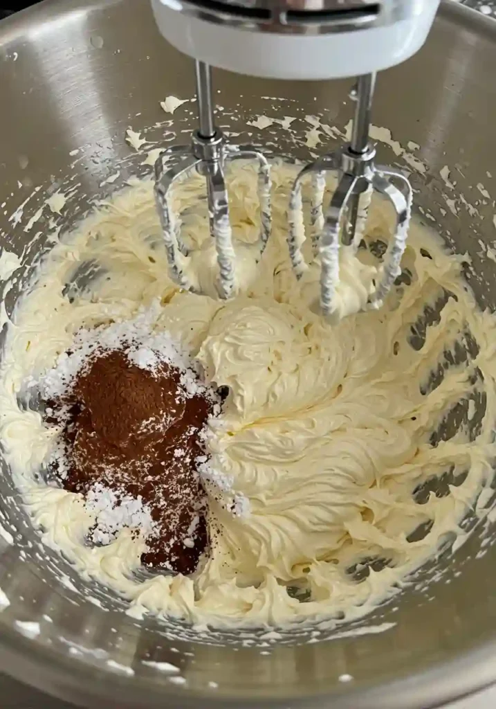 Mixing softened cream cheese and cocoa powder for chocolate cheesecake