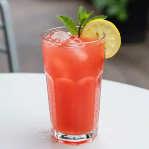 Watermelon lemonade in pitcher and glasses with ice