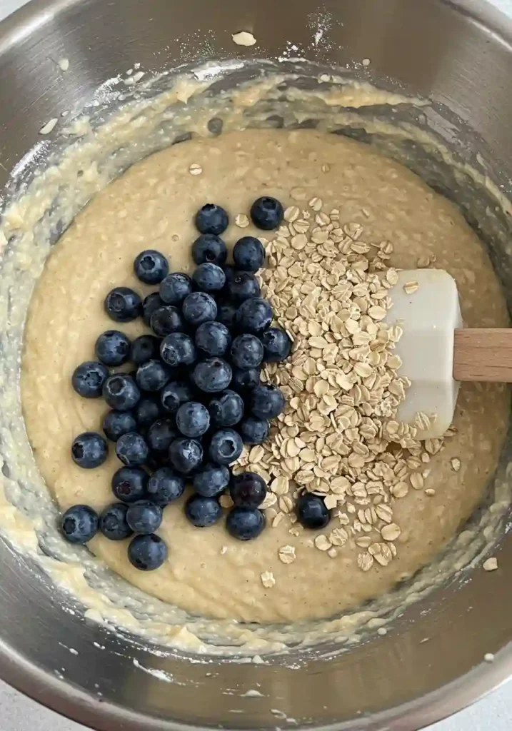 Blueberries being folded into banana muffin batter