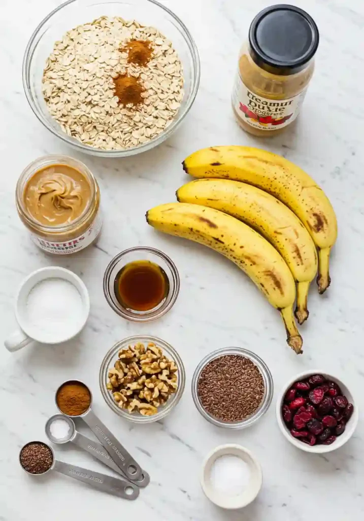 Ripe bananas, oats, peanut butter, and maple syrup arranged on a countertop