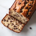 Freshly baked Greek yogurt banana bread loaf sliced on a board