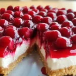 Whole no bake cherry cheesecake topped with cherries