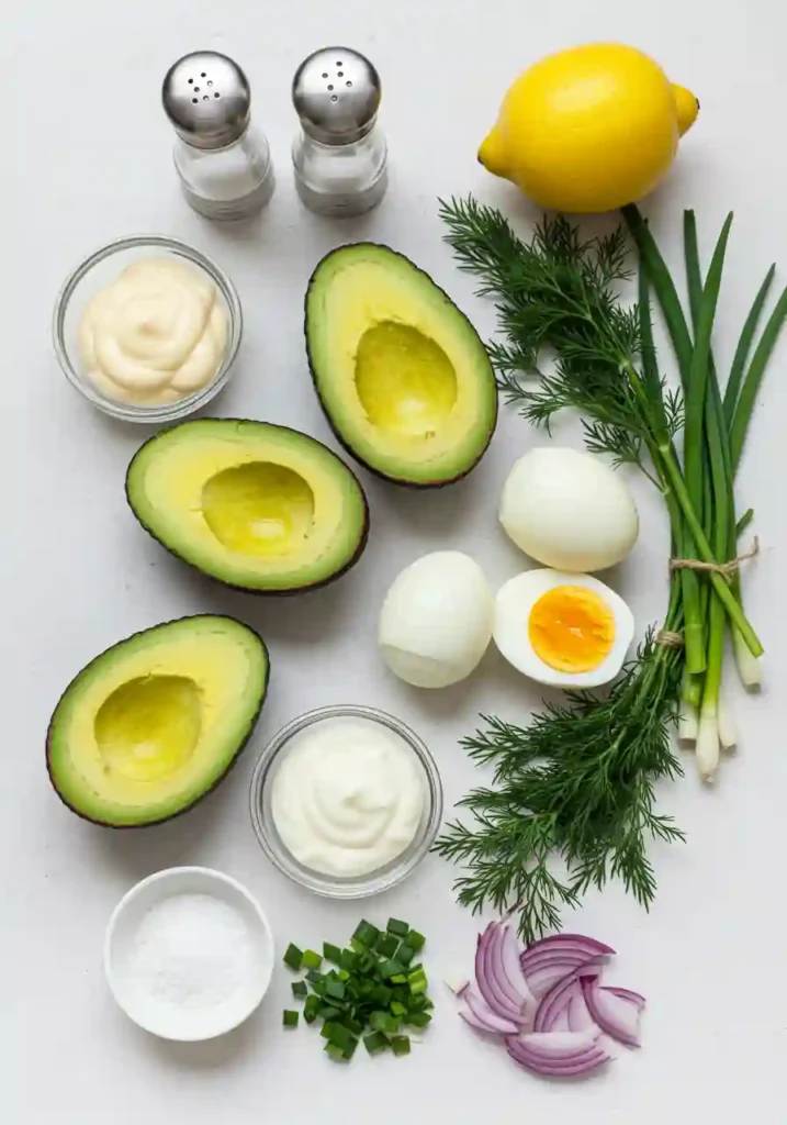 Avocados, eggs, herbs, and mayo arranged for egg salad