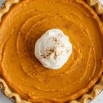 Baked sweet potato pie on a rustic wooden surface