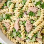 Finished tuna pasta salad in a bowl with fresh herbs