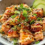 Finished Bang Bang Salmon Bowl with rice, avocado, and spicy sauce