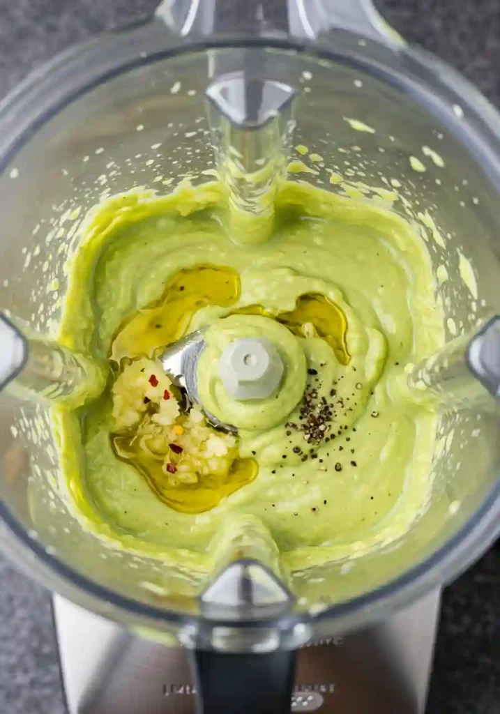 Smooth avocado dressing in a blender for the pasta salad