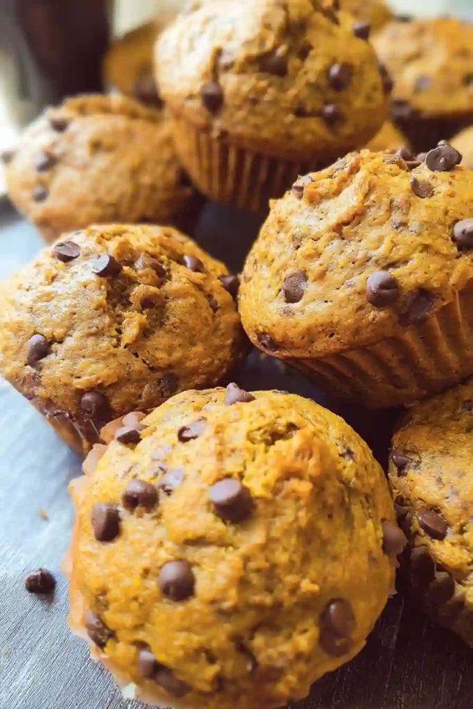 Muffin batter scooped into a 12-cup pan, topped with chocolate chips