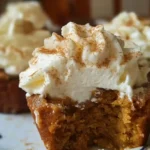 Delicious pumpkin pie cupcakes topped with whipped cream on white plate, perfect fall dessert