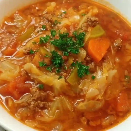 Bowl of hearty cabbage roll soup with ground beef, rice, and tender cabbage in savory tomato broth