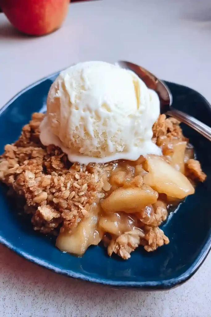 Plated sugar free apple crisp with whipped cream on dessert plate with fork